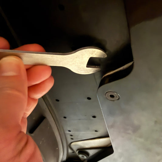 Hand holding a wrench near a Project Aero FL5 lip with mechanical component